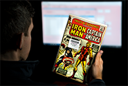 A CGC representative reviews a comic book submission to verify that its description matches information provided by the submitter.